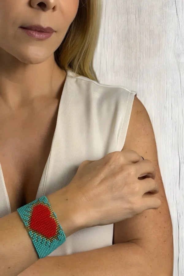 Heartbeat-of-the-Soul-bracelet-handwoven-in-Czech-beads-with-a-red-heart-design-on-a-vibrant-blue-background